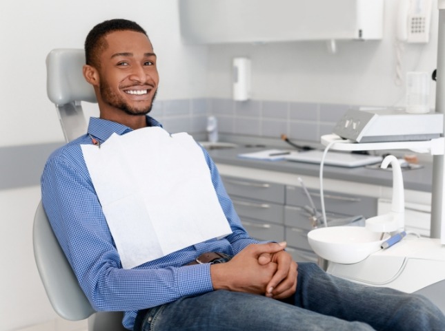 Smiling man sitting in dental chair in San Ramon dental office