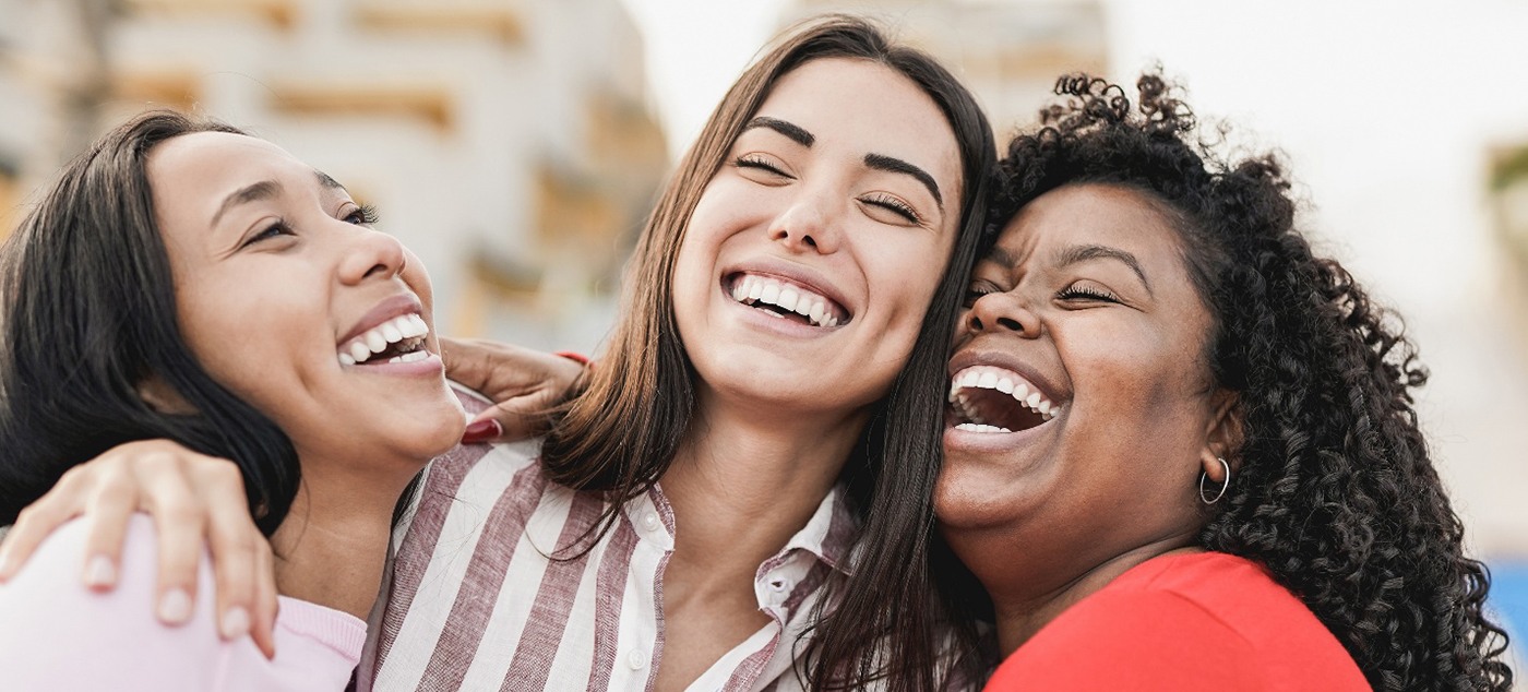 Three friends smiling together after visiting their Delta Dental dentist in San Ramon