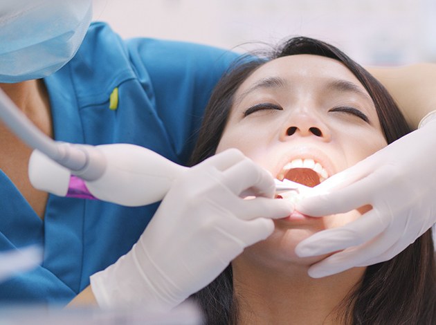 Dentist cleaning a patient’s teeth