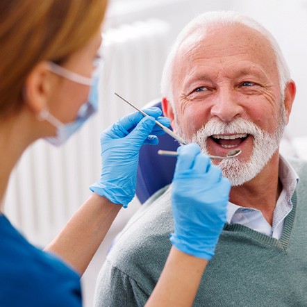 Man smiles at dentist