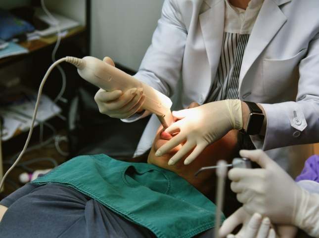 Dentist capturing digital dental impressions of a patient