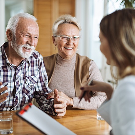 Senior couple meeting with a receptionist