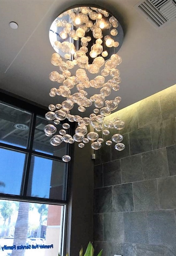 Chandelier with bubble like lights hanging from ceiling