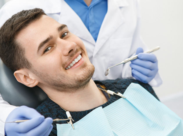 A middle-aged man admiring the results of his smile makeover