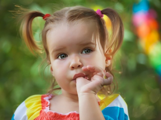 Toddler girl sucking her thumb
