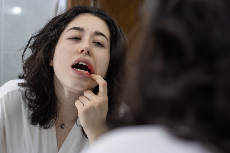 Patient looking in mirror at gum disease